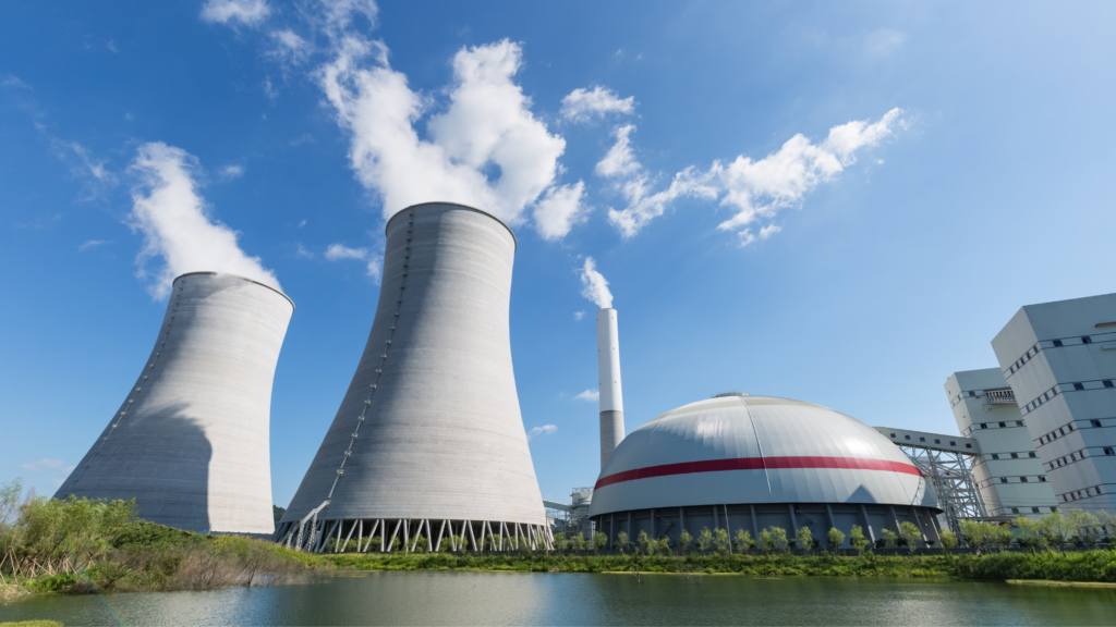 Nuclear power plant with cooling towers and a dome-shaped building. A blog on what is thermal pollution.